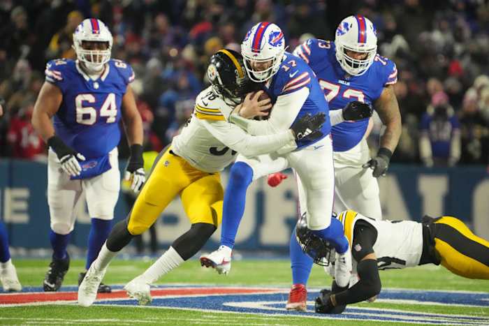 Josh Allen runs through a Steelers defender.